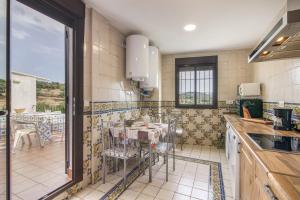 a kitchen with a table and chairs in it at El Corralon de Severo in Hinojales