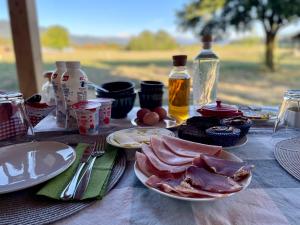 a table with plates of food on a table at B&B Woodhouse in Brezje
