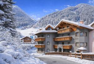 a house in the mountains with snow on the ground at Chalet Madlein in Ischgl