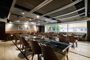 a room with tables and chairs and a large window at K Hotel - Yunghe in Yonghe