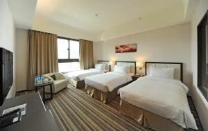 a hotel room with two beds and a television at F Hotel - Hualien - Pet-friendly in Hualien City +23 photos