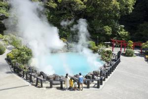 a group of people standing in front of a group of elephants at Ooedo Onsen Monogatari Premium Hotel Fugetsu in Beppu