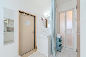 a bathroom with a sink and a mirror at Mary's Room Hakata in Sumiyoshi