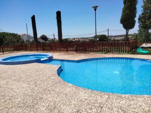 a swimming pool with blue water in a yard at Almaden 7A in Castilblanco de los Arroyos