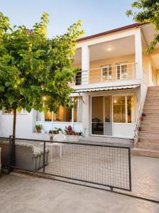 a house with a fence in front of it at Apart Portakal Çiçeği in Kaş