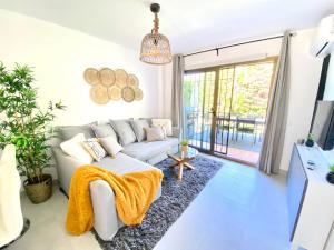 a living room with a couch and a tv at Wave & Garden Riviera - EaW Homes in Mijas Costa