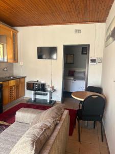 a living room with a couch and a table at Phapel Home-Away in Pretoria