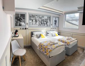 a bedroom with two beds and a desk at Central Station Hotel Liverpool in Liverpool +28 photos