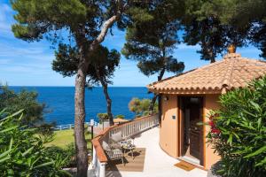 a house with a balcony with a view of the ocean at Seafront Collection - Bungalows and Villas in Aspra