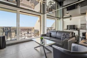 a living room with a couch and a table at Studio Naturiste Design in Cap d'Agde