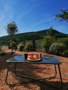 a table with a plate of food on top of it at La Bauderie in Bussières