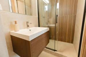a bathroom with a sink and a shower at Pensiunea Mario in Beiuş