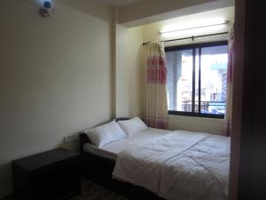 Katil atau katil-katil dalam bilik di Hotel Sunflower