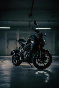 a black motorcycle parked in a parking garage at Grand Hôtel & Spa NUXE Serre Chevalier in Saint-Chaffrey