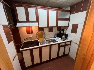 a small kitchen with a sink and a stove at Rahat Ev in Ganja +4 photos