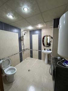 a bathroom with a toilet and a sink at Rahat Ev in Ganja