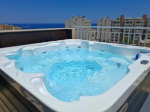 a jacuzzi tub sitting on top of a building at Zyra Hotel St Julians - Adults only in St. Julianʼs