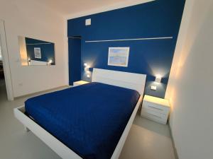 a blue bedroom with a bed and two night stands at Country House Atessa in Atessa