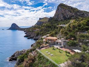 a house on a cliff next to the ocean at Seafront Collection - Bungalows and Villas in Aspra +155 photos