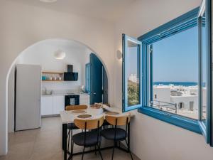 a kitchen and dining room with a table and chairs at Kamara House - 200m from Naoussa Port in Naousa