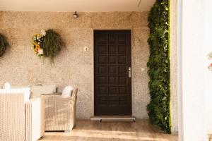 a black door on the side of a house at Villa Montalvo Beach-Piscina climatizada in Montalvo +88 photos