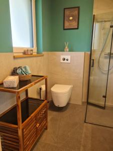 a bathroom with a toilet and a glass shower at 5lakes & nature in Starnberg +25 photos