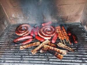 a bunch of meats and sausages on a grill at Casa Noa in Huesca