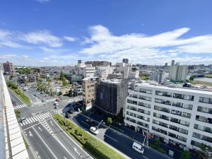 an aerial view of a city with a street and buildings at Kameari 1110 - 11F Newly Renovated High Floor City View 2min to Mall 5min to Station Disney Access in Tokyo