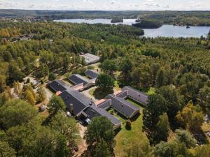 an aerial view of a building with trees and a lake at Ekängens vandrarhem in Virserum
