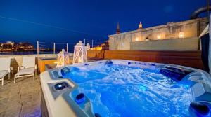 a jacuzzi tub on the roof of a building at Valletta Waterfront Villa with Pool and Jacuzzi in Valletta