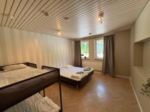 a room with two bunk beds and a window at Ekängens vandrarhem in Virserum