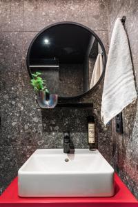 a bathroom with a white sink and a mirror at Savoy Hotel in Frankfurt
