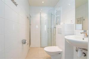 a bathroom with a toilet and a sink and a shower at Hemavan Mountain Lodge Jofjället in Hemavan