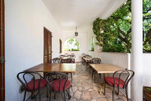 a dining room with wooden tables and chairs at Hotel Dubrava in Budva
