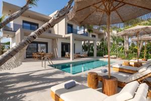 a villa with a swimming pool and a resort at Palmeral Luxury Villas in Kremasti