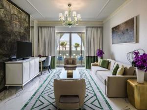 a living room with a couch and a table at Rixos Premium Saadiyat Island - All Inclusive in Abu Dhabi