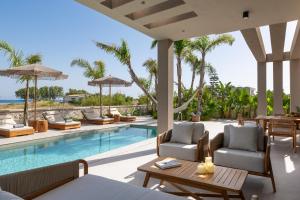 a villa with a swimming pool and a resort at Palmeral Luxury Villas in Kremasti