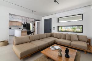 a living room with a couch and a table at Palmeral Luxury Villas in Kremasti