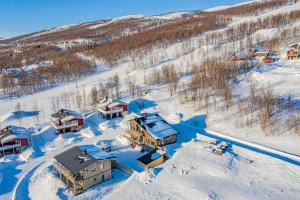 an aerial view of a house in the snow at Hemavan Mountain Lodge Jofjället in Hemavan +6 photos