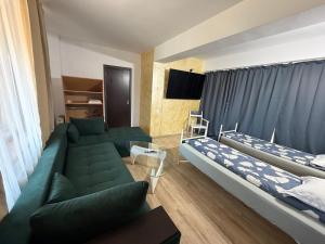 a living room with two beds and a couch at Hypnotic Boutique Pitesti in Piteşti