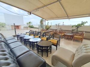 a group of chairs and tables and tables and chairs at Hotel Chandigarh Grand in Chandīgarh