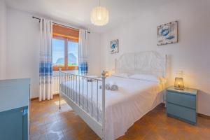 a bedroom with a white bed and a window at Villa Ortembach- PlusHolidays in Ifach +68 photos