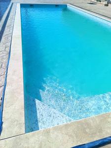 a swimming pool with a clear blue water at Casa Sofia in Târgu Jiu