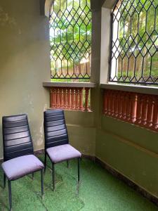 two chairs in a room with stained glass windows at Amboseli 2 in Mombasa