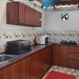 a kitchen with a sink and a microwave at Airin's Villa in Agali