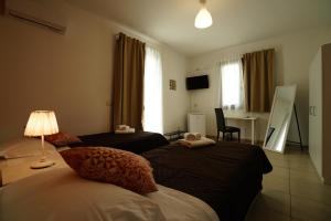 a hotel room with two beds and a desk at TERRA MIA in Città Giardino
