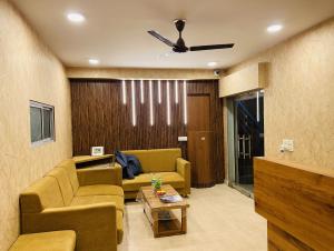 a living room with a couch and a ceiling fan at AVON Homes in Jodhpur