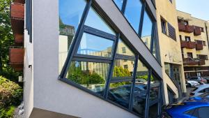 a window on a building with a reflection of a parking lot at Blue Salt in Wieliczka
