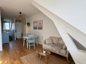 a living room with a couch and a table at Cozy studio in Cancale in Cancale