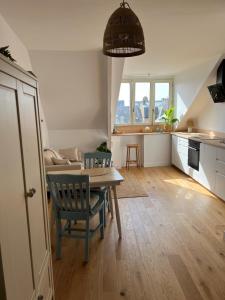 a kitchen and living room with a table and a dining room at Cozy studio in Cancale in Cancale +8 photos